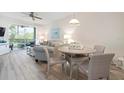 Cozy living and dining area with a ceiling fan, plush furniture, a small table and balcony access with scenic views at 9630 Club South Cir # 6201, Sarasota, FL 34238