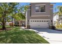 Charming two-story home with a manicured lawn and two-car garage at 10615 Boyette Creek Blvd, Riverview, FL 33569