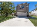 Charming two-story home with a manicured lawn and two-car garage at 10615 Boyette Creek Blvd, Riverview, FL 33569