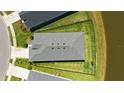 Aerial view of the property, revealing a spacious fenced yard, and proximity to a serene pond at 11869 Richmond Trl, Parrish, FL 34219