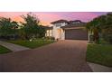 Charming single-Gathering home with a paved driveway, lush lawn, and mature landscaping at 14514 20Th E St, Parrish, FL 34219