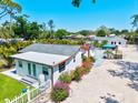 Backyard with a lush green lawn, white picket fence, and attractive landscaping, creating a serene outdoor space at 1518 Stoeber Ave, Sarasota, FL 34232