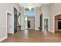 Spacious foyer featuring high ceilings, modern decor, and a stylish front door with sidelights at 1555 Eastbrook Dr, Sarasota, FL 34231