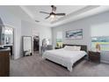 Spacious main bedroom features a tray ceiling, plush carpet, and a view of the water at 16161 61St E Ln, Parrish, FL 34219