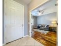 Welcoming foyer leading to a living area with hardwood floors and a gray sofa at 16848 Rosedown Gln, Parrish, FL 34219