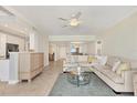 Open concept living room featuring eat-in kitchen and dining area, comfortable seating, and tile floors at 1800 Benjamin Franklin Dr # B310, Sarasota, FL 34236