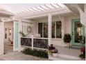 Covered porch area featuring a seating area and a stylish teal front door at 1907 4Th W St, Palmetto, FL 34221