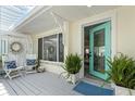 Home's front porch featuring a seating area and plants at 1907 4Th W St, Palmetto, FL 34221