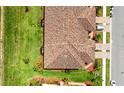 Aerial view of a beautiful townhome featuring manicured landscaping and a colorful roof at 20398 Lagente Cir, Venice, FL 34293