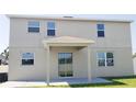 Back exterior with windows and covered patio with sliding glass doors to the interior at 215 63Rd E Dr, Bradenton, FL 34203