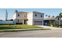 Charming two-story home with a well-manicured lawn and an attached two-car garage at 215 63Rd E Dr, Bradenton, FL 34203
