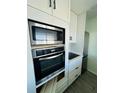 Modern kitchen showcasing stainless steel appliances and stylish white cabinetry at 3101 Bee Ridge Rd # 221, Sarasota, FL 34239