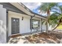 Inviting home exterior with a charming front porch and a beautiful palm tree in the front yard at 322 Linden Dr, Ellenton, FL 34222