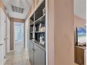Inviting hallway with built-in shelving leading to a bathroom, enhancing the home's functionality and style at 322 Linden Dr, Ellenton, FL 34222