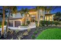 Stunning home with lush landscaping, inviting entrance, and a two-car garage at 3272 Bayou Rd, Longboat Key, FL 34228