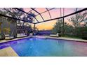 Beautiful pool area with a heated spa and expansive screened in lanai and waterfront views at 3272 Bayou Rd, Longboat Key, FL 34228