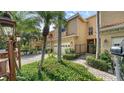 Attractive townhome with lush landscaping, a brick driveway, and gated front entrance at 3623 Square West Ln # 5, Sarasota, FL 34238