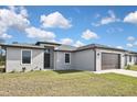 Charming single-story home with a well-kept lawn and attached two-car garage at 3812 Wenona Dr, North Port, FL 34288