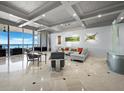 Bright living room with floor to ceiling windows, sleek furniture and designer touches with beautiful ocean view at 415 L Ambiance Dr # D306, Longboat Key, FL 34228
