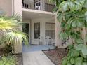 Cozy condo entrance with seating area and tropical foliage at 4315 45Th W Ave # 103, Bradenton, FL 34210