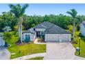Beautiful single-story home featuring a paver driveway, mature landscaping, and a neutral color palette at 437 Chantilly Trl, Bradenton, FL 34212