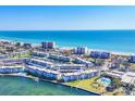 Panoramic aerial view showcasing the condo community, pools, and beautiful beachfront access at 4380 Exeter Dr # 304, Longboat Key, FL 34228