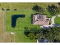 A property with a unique pond and landscaping, completely surrounded with privacy fencing at 4610 13Th W St, Palmetto, FL 34221