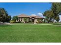 Beautifully landscaped home exterior with a sprawling lawn and inviting facade under a blue sky at 4610 13Th W St, Palmetto, FL 34221