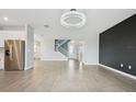 Open floor plan with sleek hardwood floors and a stunning chandelier at 4951 Oyster Pearl St, Lakewood Ranch, FL 34211