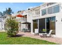A cozy patio with a lounge chair and outdoor seating invites relaxation in a sunny spot at 5055 Gulf Of Mexico Dr # 414, Longboat Key, FL 34228