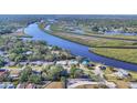Scenic aerial view showcasing a stunning river, lush greenery, and surrounding homes at 5206 18Th E Ave, Bradenton, FL 34208