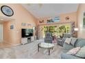 Bright and airy living room with vaulted ceilings, neutral decor, and a view of the lanai at 6339 Bay Cedar Ln # 102, Bradenton, FL 34203
