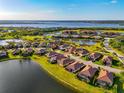 Aerial view of home in a waterfront community with lake and golf course views at 6524 Willowshire Way, Bradenton, FL 34212