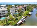 An aerial view of a stunning property with a pool, dock, and lush landscaping at 7118 Hawks Harbor Cir, Bradenton, FL 34207