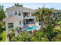 Aerial view of home showcasing a pool, hot tub, outdoor lounge area and lush tropical landscaping at 7118 Hawks Harbor Cir, Bradenton, FL 34207