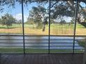 Relaxing screened patio with scenic views of the tranquil pond and golf course at 7461 W Country Club N Dr # 201, Sarasota, FL 34243