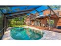 Sparkling pool with a screened enclosure and adjacent patio for relaxation and entertainment at 801 Oak Vista Dr, Sarasota, FL 34232