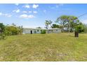 Expansive backyard showing rear exterior of the house on a sunny day at 815 31St W Ave, Palmetto, FL 34221