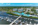 Stunning aerial view capturing a marina, waterfront condos, lush greenery, and charming city streets at 1000 Riverside Dr # B202, Palmetto, FL 34221