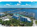 A scenic aerial view featuring the marina, a bridge, open water, and waterfront condominiums at 1000 Riverside Dr # B202, Palmetto, FL 34221