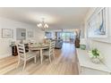 Open-concept living and dining area with light wood floors and sliding glass doors to a balcony at 1000 Riverside Dr # B202, Palmetto, FL 34221