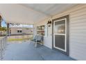Inviting covered front porch with a cozy seating area and clear view of the neighborhood at 10315 Cortez W Rd # 24-5, Bradenton, FL 34210