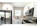 Well-appointed kitchen with stainless steel appliances and white cabinetry at 1142 Newhope Rd, Spring Hill, FL 34606
