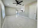 Open-concept living room and kitchen with new tile floors and fresh paint at 1142 Newhope Rd, Spring Hill, FL 34606