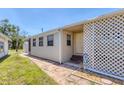 Charming home exterior featuring a lattice-covered porch and tidy landscaping at 1307 41St E Ave, Ellenton, FL 34222