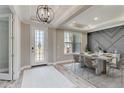 Bright dining room with white marble table, modern light fixture, and stylish accent wall at 14914 15Th E St, Parrish, FL 34219