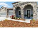 Inviting single-Gathering home with stone arches, mature landscaping, and a spacious two-car garage at 14914 15Th E St, Parrish, FL 34219