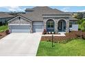 Charming single-Gathering home with stone accents, a well-kept lawn, and a convenient two-car garage at 14914 15Th E St, Parrish, FL 34219