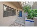 Inviting entryway with tiled accents, a blue glass door, and mature landscaping creating a private entrance at 1612 Starling Dr # 101, Sarasota, FL 34231