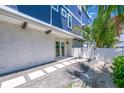 Side view of the home with a white fence and walkway at 201 Bay N Dr, Bradenton Beach, FL 34217